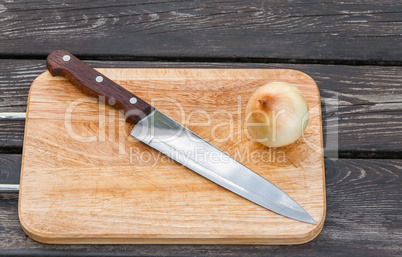 Knife,onion and a cutting board