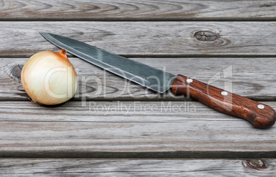 Knife,onion on a table