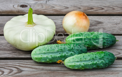 Squash, onions and cucumbers on table