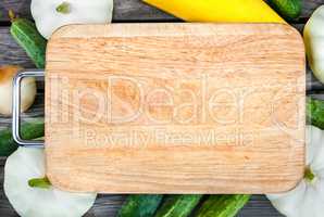 Cutting board, fresh vegetables on wooden table.  Top view with