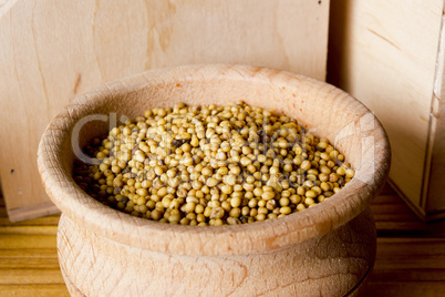 Mustard seeds with a wooden bowl