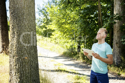 Man in the woods with Tablet PC