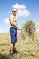 Man turns hay in the meadow