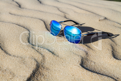 Sunglasses on the sand in the desert.