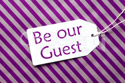 Label On Purple Wrapping Paper, Text Be Our Guest