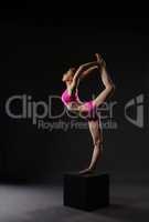 Redhead ballerina doing vertical gymnastic split