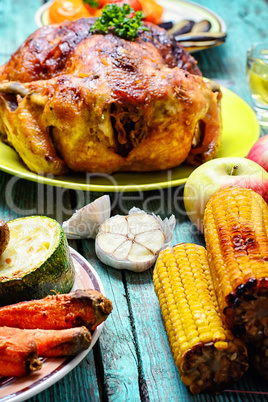 Roasted chicken on wooden plate