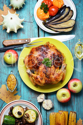 Roasted chicken on wooden plate