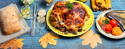 Roasted chicken on wooden plate