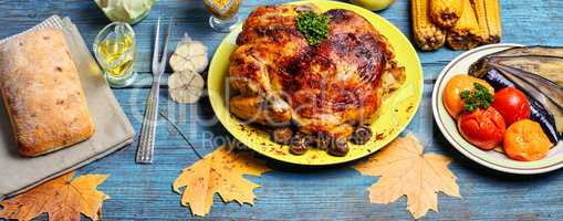 Roasted chicken on wooden plate