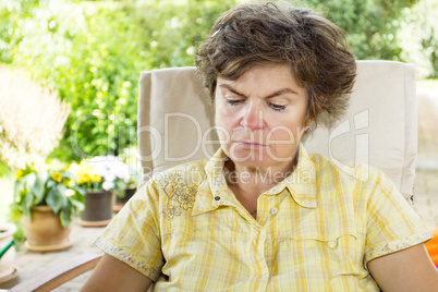 Woman sitting in the garden and reading