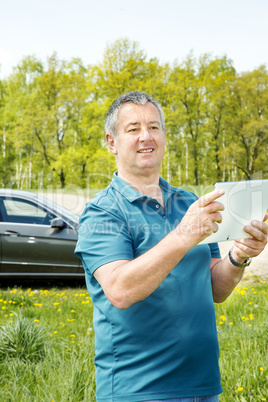 Man with Tablet PC and car