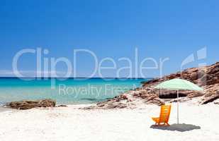 Lounge chair with sun umbrella on a beach