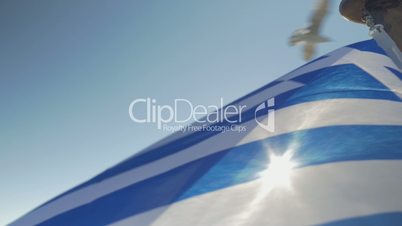 Close up Greece flag waving against sun