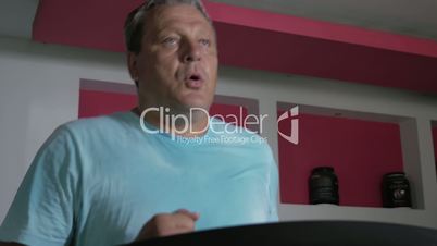Full adult male runs on a treadmill