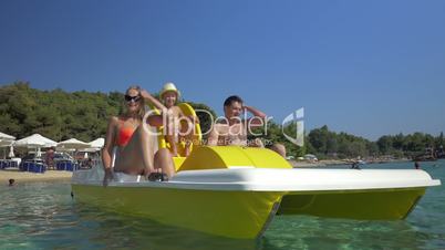 Family with child enjoying pedal boat ride