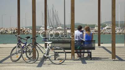 Couple with digital tablet on waterfront