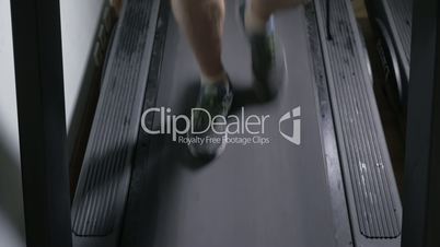 Adult male in sneakers walking on a treadmill