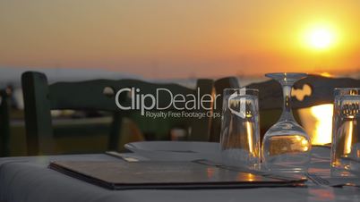 Served table in outdoor restaurant at sunset