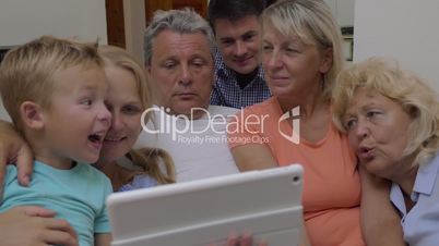 Family watching video on tablet computer