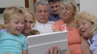 Big family with child watching tablet computer