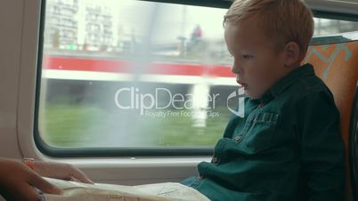 Child looking at map in the train