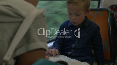 Mother and child exploring map in train