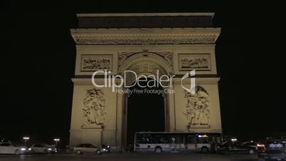 Night shot of Arc de Triomphe and car traffic in Paris