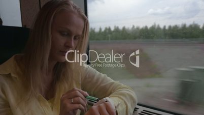 Woman using smart watch during train ride