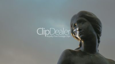 Face of Little Mermaid statue against sky background