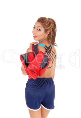 Woman standing with boxing cloves.