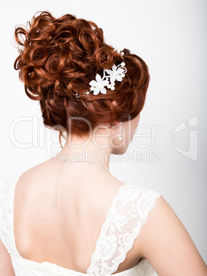 close-up portrait of young beautiful bride in a wedding dress with a wedding makeup and hairstyle.