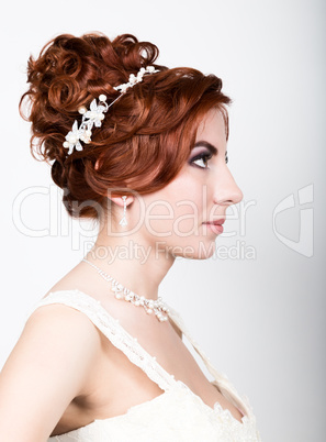 close-up portrait of young beautiful bride in a wedding dress with a wedding makeup and hairstyle.