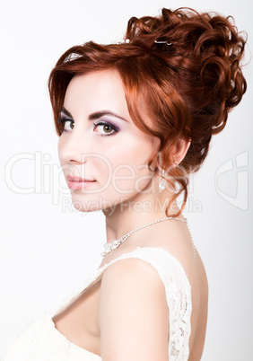 close-up portrait of young beautiful bride in a wedding dress with a wedding makeup and hairstyle.