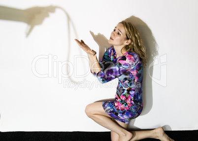 frightened woman standing near the wall with a faceless man holding a belt, a conceptual shoot portraying the process and effects of domestic violence