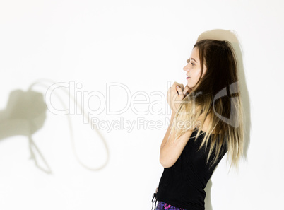 frightened woman standing near the wall with a faceless man holding a belt, a conceptual shoot portraying the process and effects of domestic violence