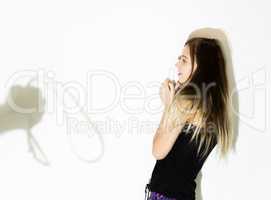 frightened woman standing near the wall with a faceless man holding a belt, a conceptual shoot portraying the process and effects of domestic violence