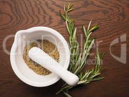 Dried rosemary in a mortar with a pestle