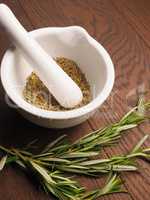 Rosemary with a white mortar and pestle