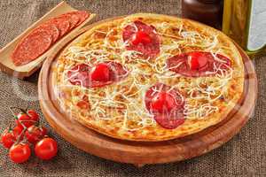 Salami pizza with cherry tomatoes