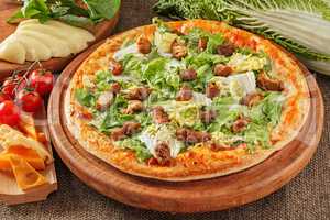 Pizza with meat and salad
