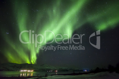 Strong bright green aurora northern lights over mountain