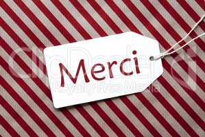 Label On Red Wrapping Paper, Merci Means Thank You