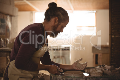 Male potter making a pot