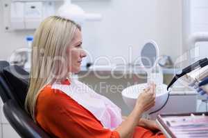 Patient checking her teeth in mirror