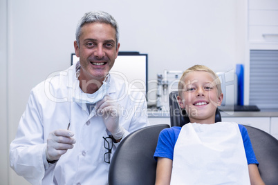 Portrait of smiling dentist and young patient