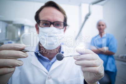 Dentist holding dental tools