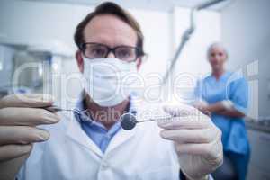 Dentist holding dental tools