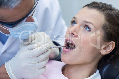 Patient teeth being examined with angle mirror