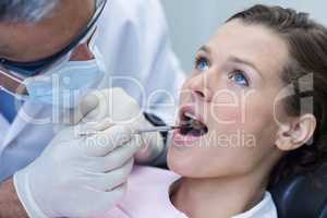 Patient teeth being examined with angle mirror